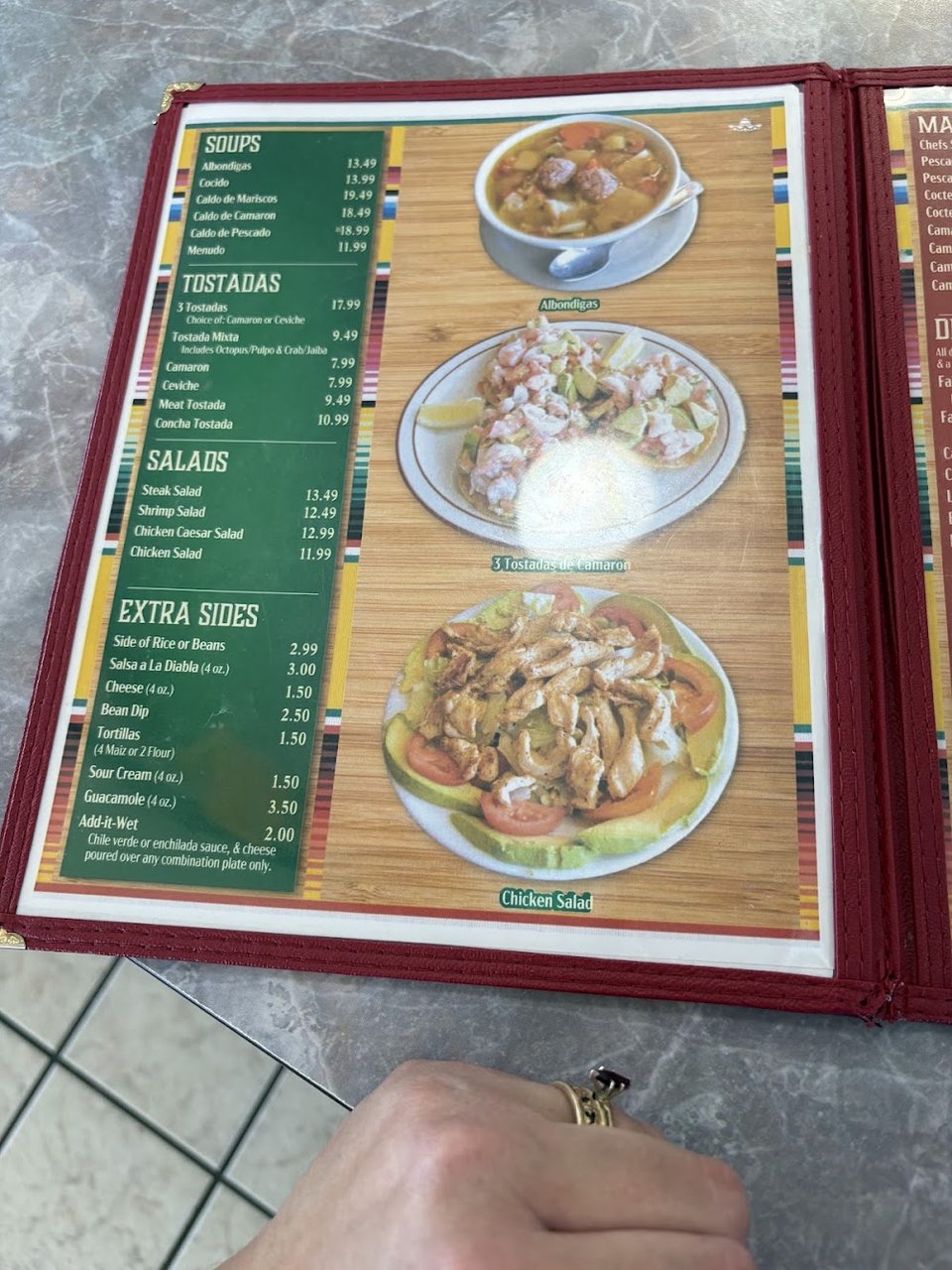 Food menu with wet burrito and caldo de mariscos.